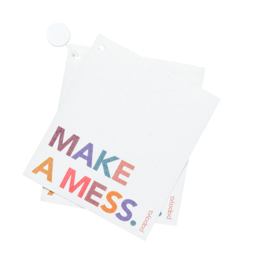 Two reusable paper towels and a hanging hook that says make a mess in fun colors